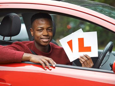 Smiling Teenage Boy In Car Passing Driving Exam